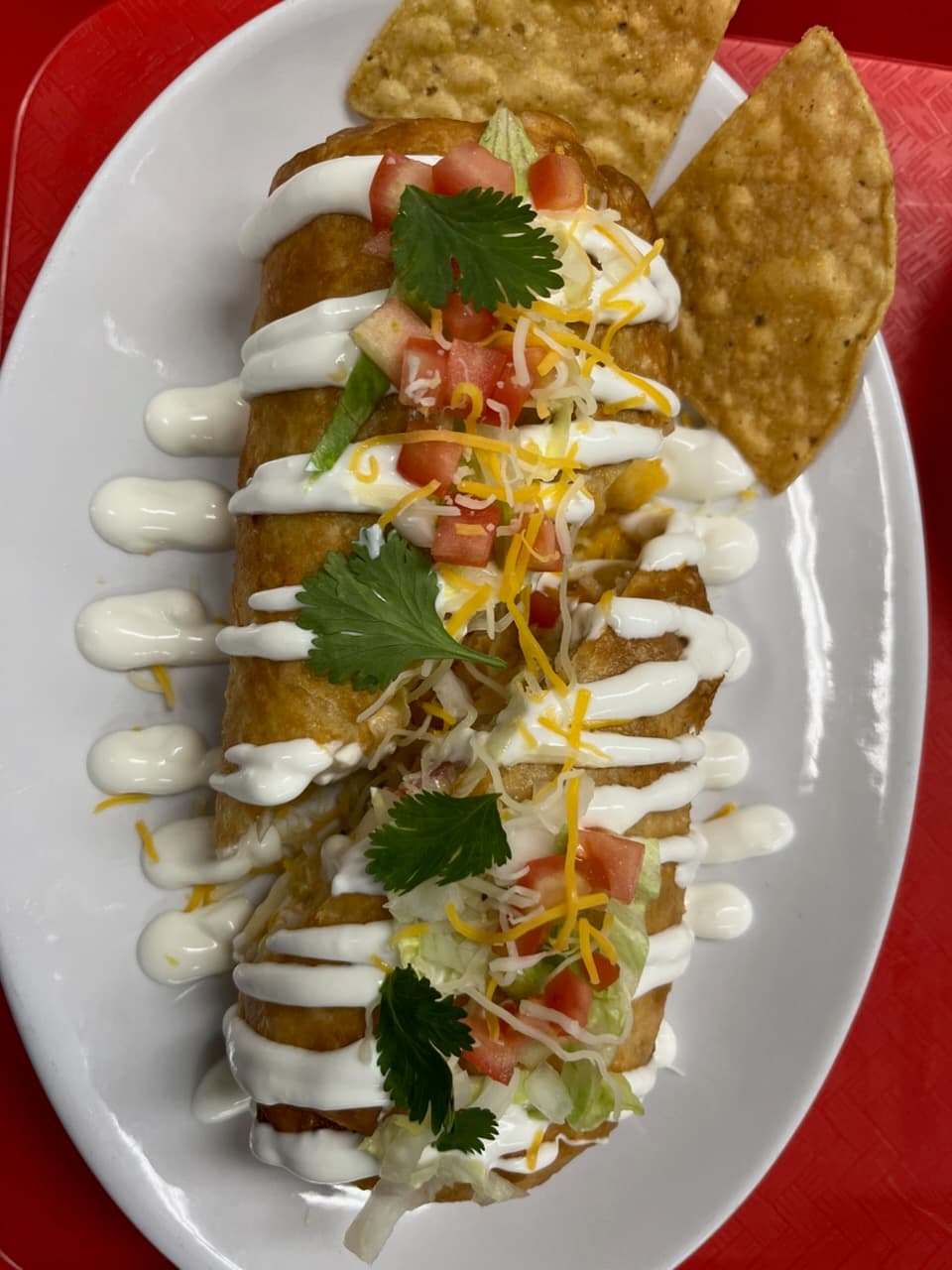 Chimichanga with crema, cheese, and tomato from Melendez Imports