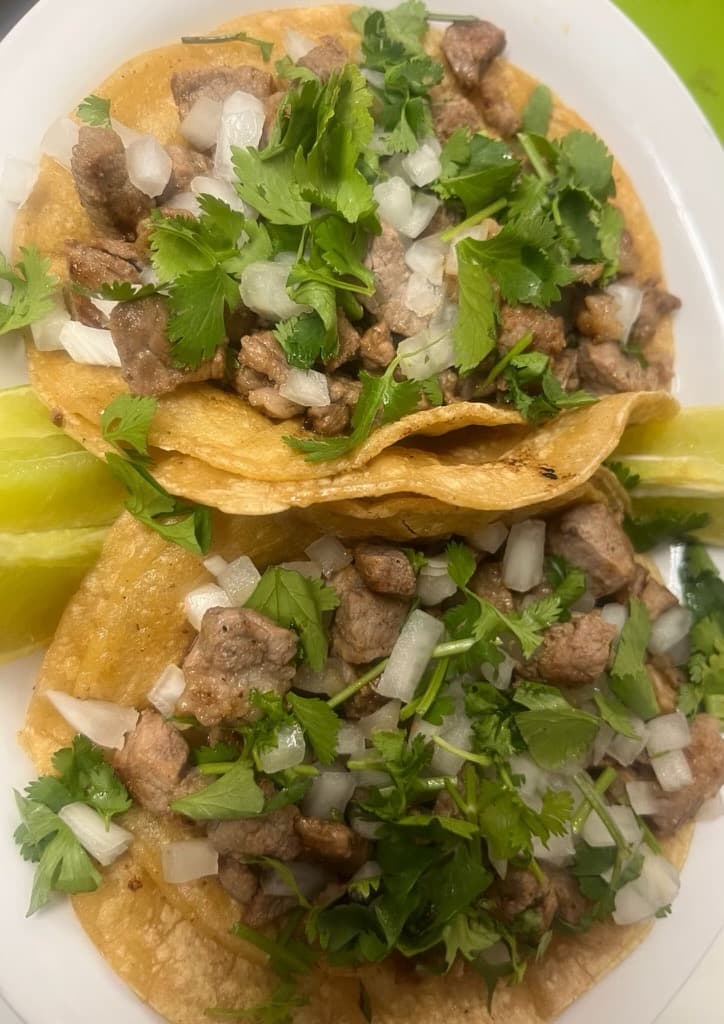 Corn tacos with carne asada, onion, and cilantro from Melendez Imports