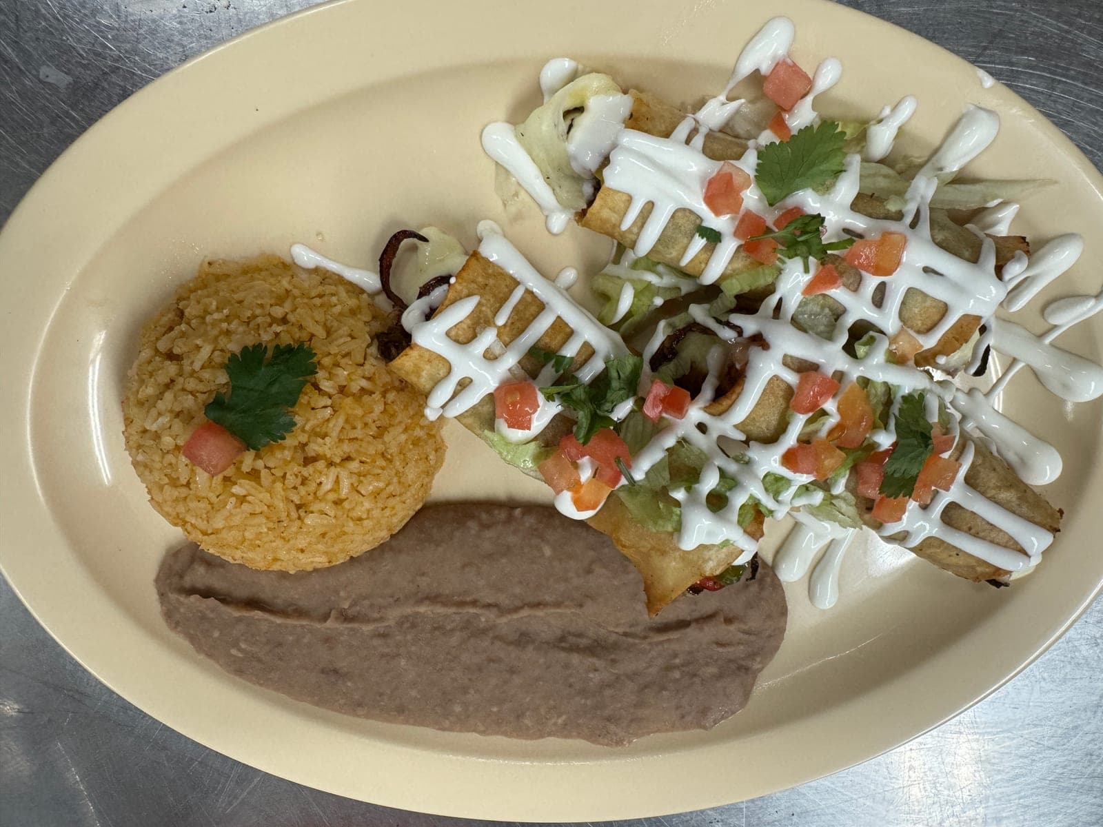 Flautas with rice, beans, and crema from Melendez Imports