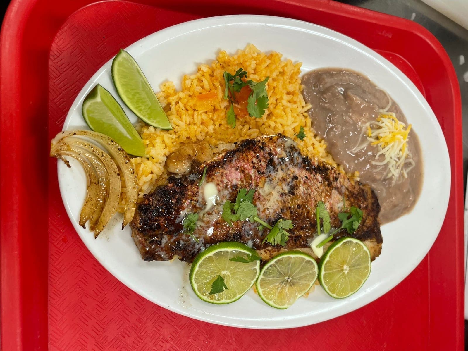 Grilled fish plate with rice and beans from Melendez Imports