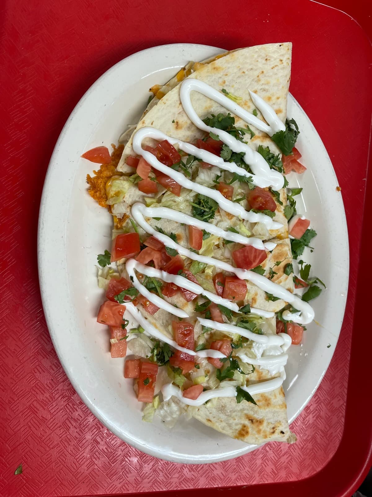 Quesadilla with crema, lettuce, and tomato from Melendez Imports
