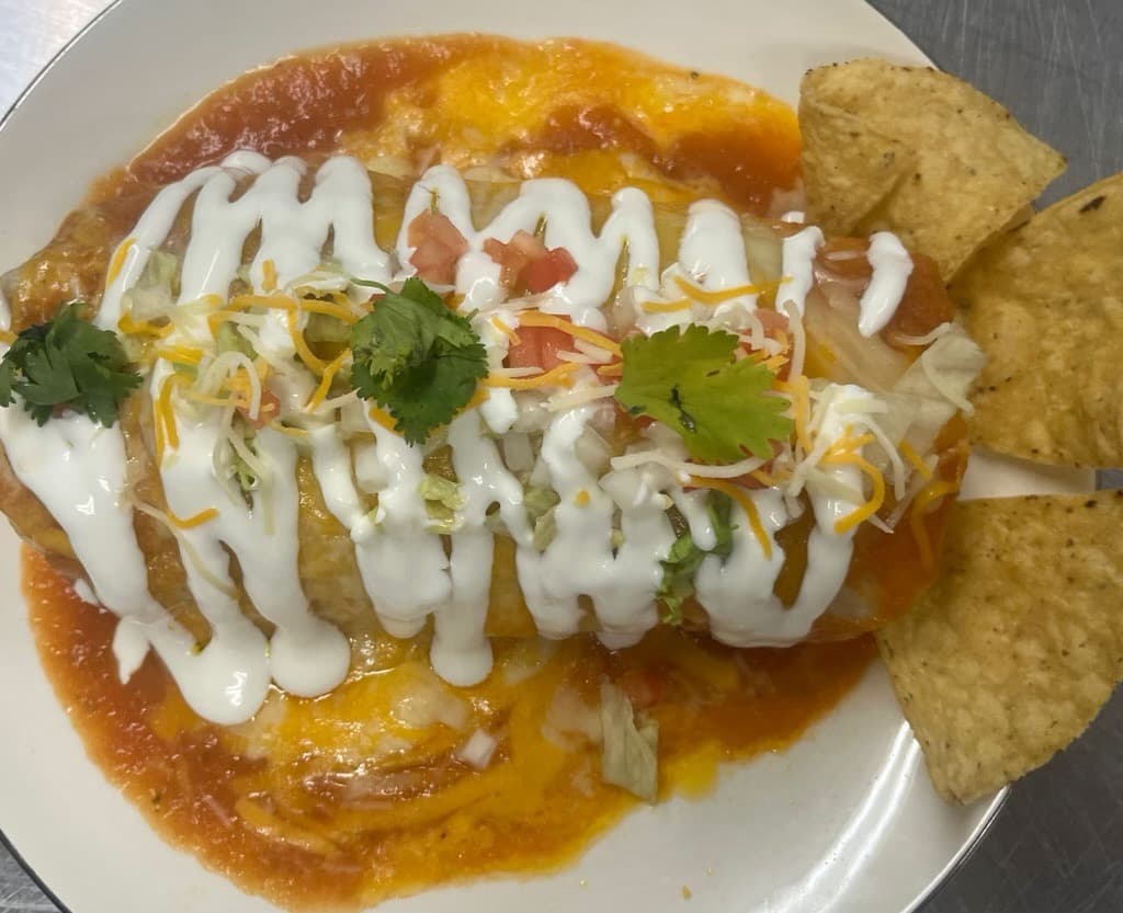 Wet burrito with cheese, crema, and chips from Melendez Imports